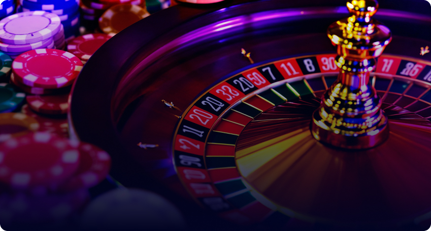 A detailed shot of a glowing Multicasino roulette wheel at night