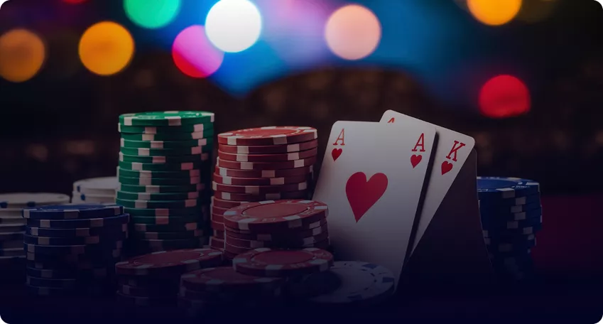 A pair of aces next to poker chips at a Multicasino table